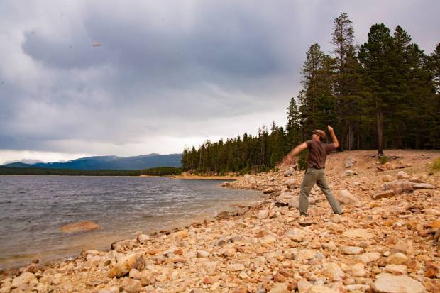 Ryan throwing rocks into lakes in Leadville, Colorado